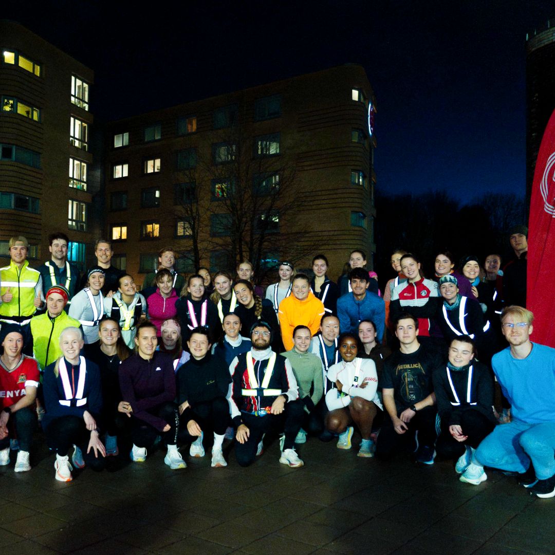 Foto av mange studenter som står klare til å jogge i kveldslys.
